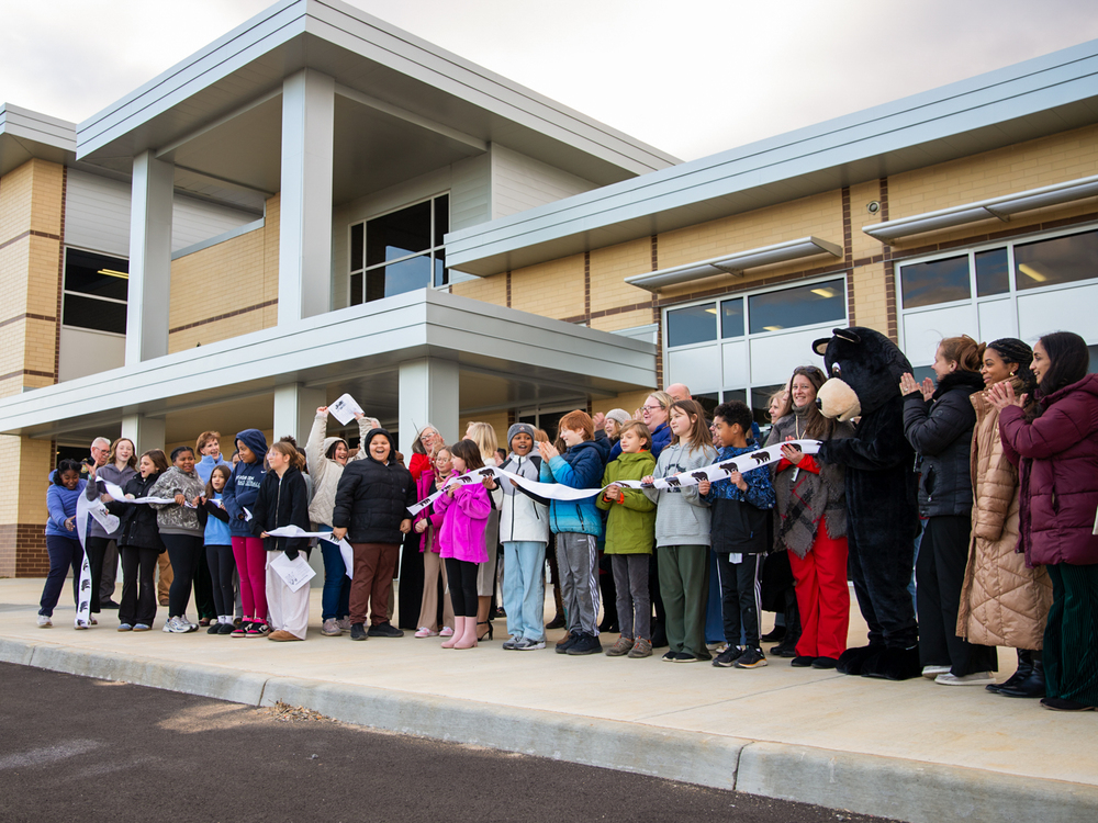 Students celebrating the ribbon-cutting in front of the new SES