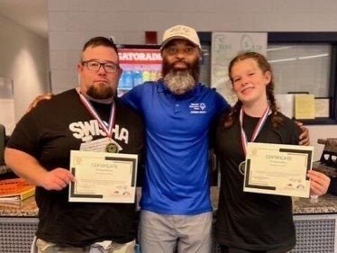 Mason and Brynlie Austin with Marcus Leggett,  president of logistics and events for Special Olympics of Virginia Beach
