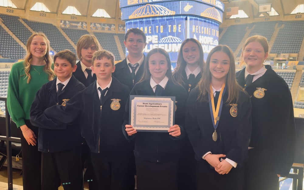 FFA members with their certificate standing in the state arena