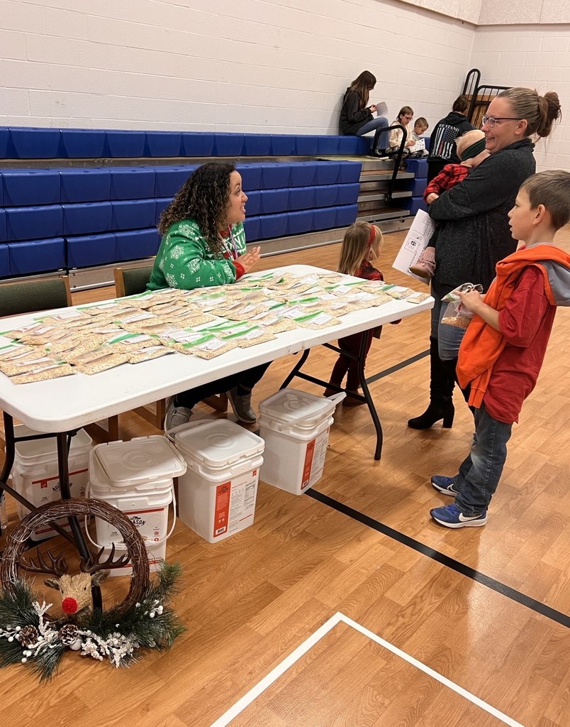 Teacher talks with family at an activities station