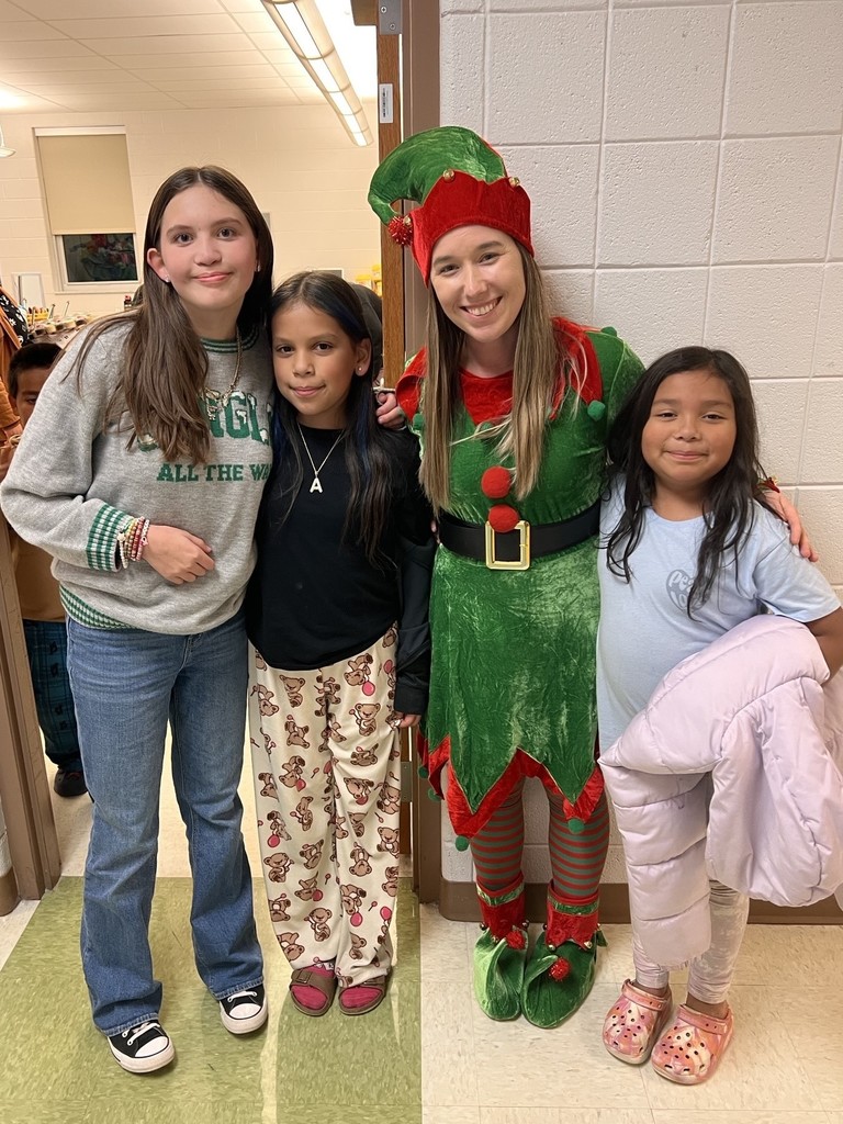 Three young girls with a volunteer dressed as an elf
