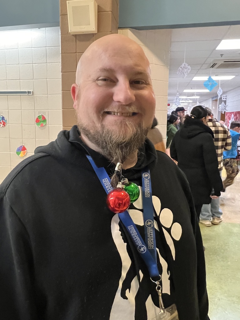 Man with Christmas ornaments dangling from his beard