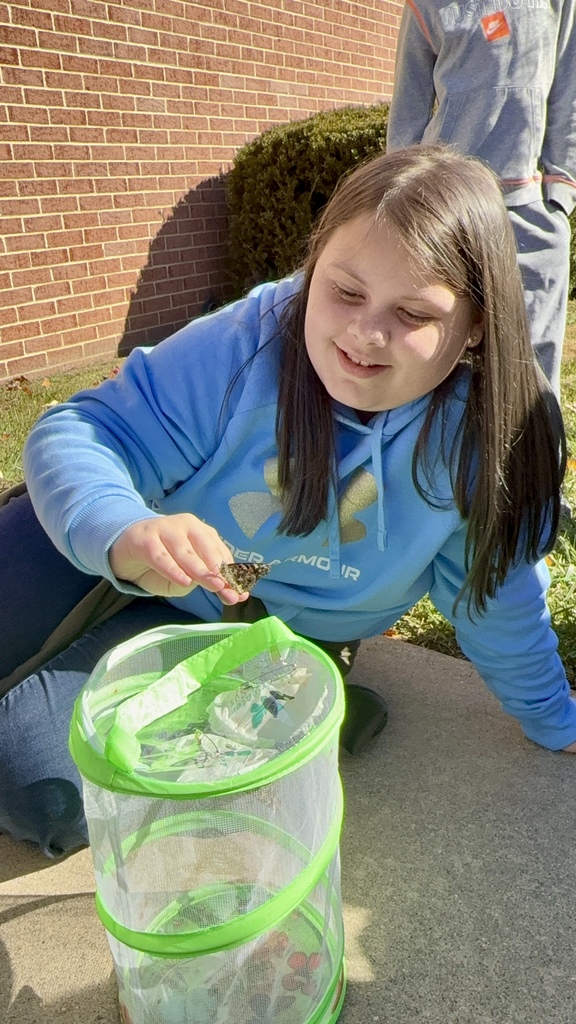 student holding butterfly