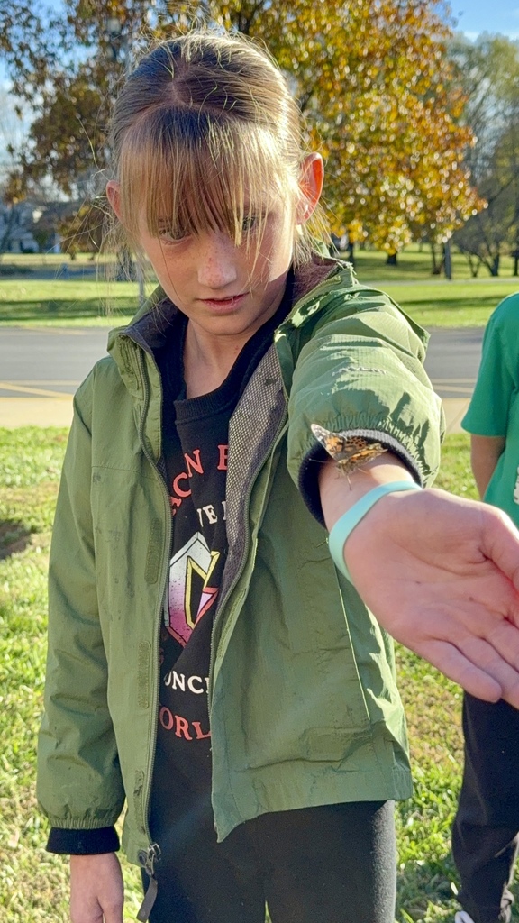 student holding butterfly