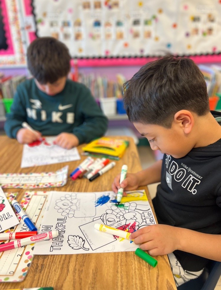 two boys working on a thankfulness book