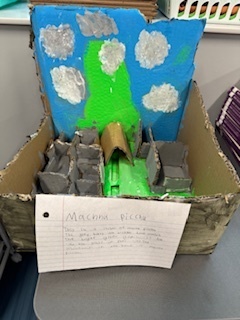 A diorama of Machu Picchu with buildings, landforms, and the sky
