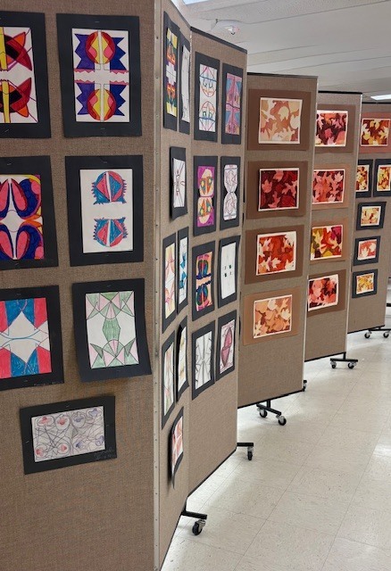 Student artwork displayed on stands