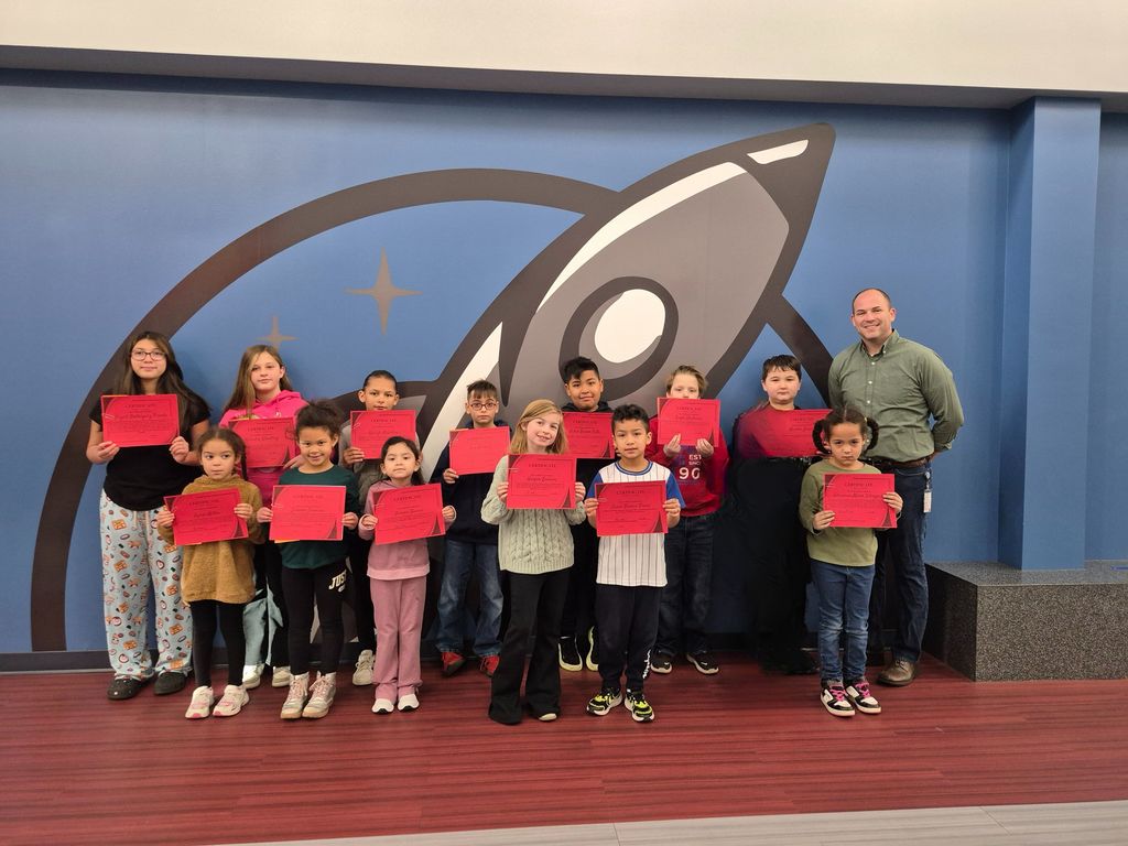 K-5 students posing with Mr. Astorino