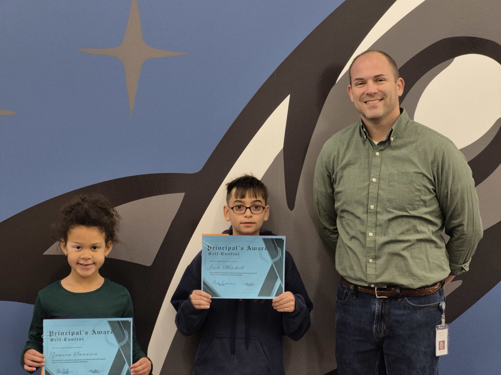 Two students posing with Mr. Astorino