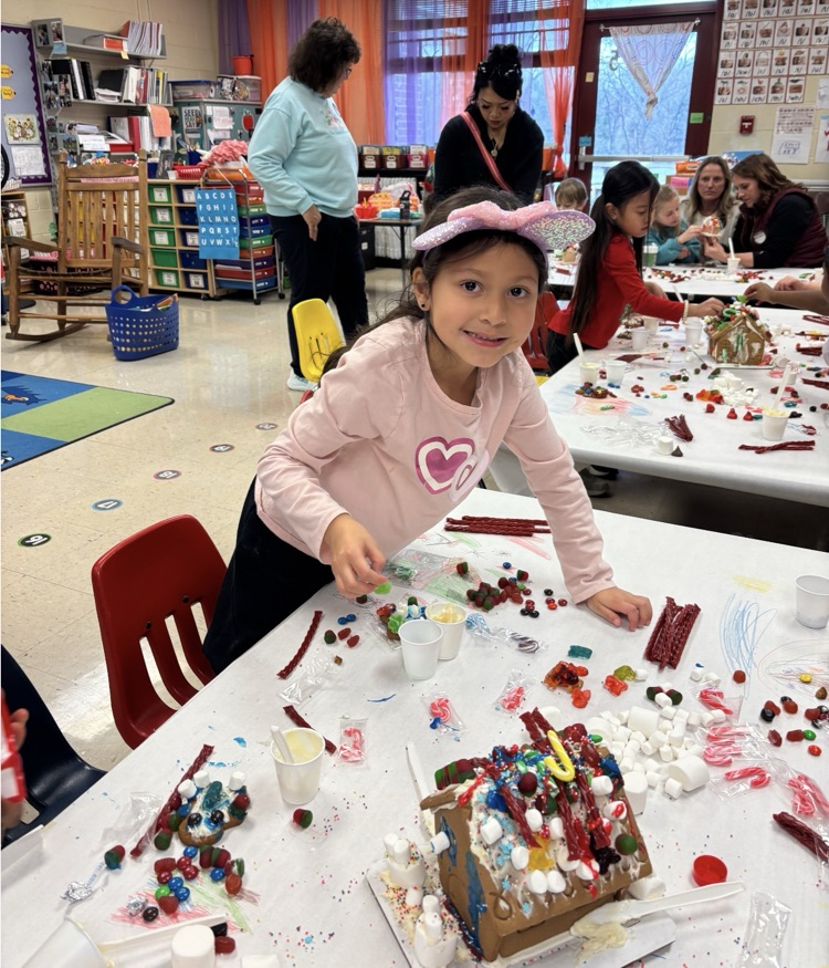 kids with gingerbread house 