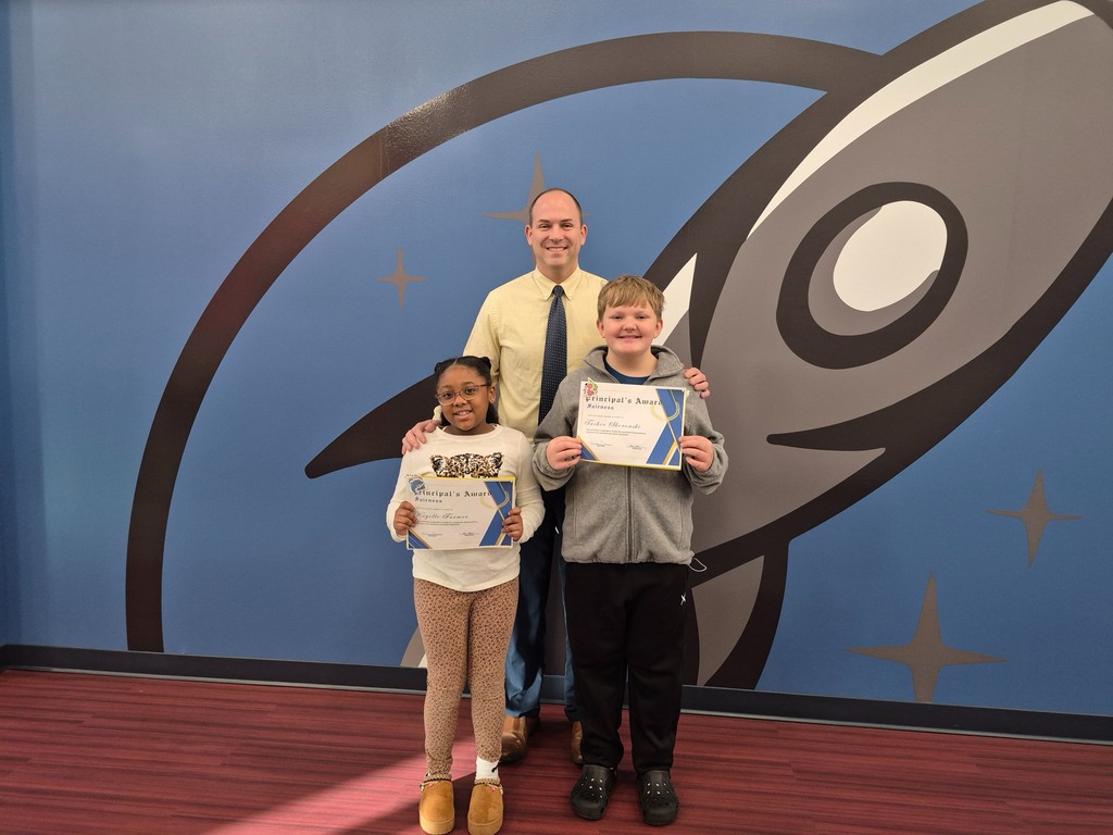 Two students posing with Mr. Astorino