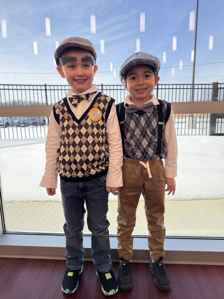 Kindergarten students wearing sweaters, suspenders, and fake eyebrows