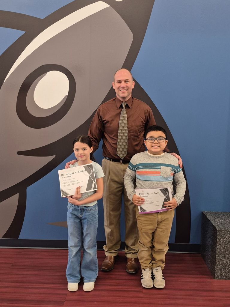 Two students posing with Mr. Astorino with their certificates
