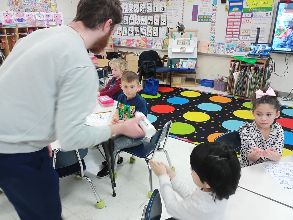 students getting fluorescent lotion on