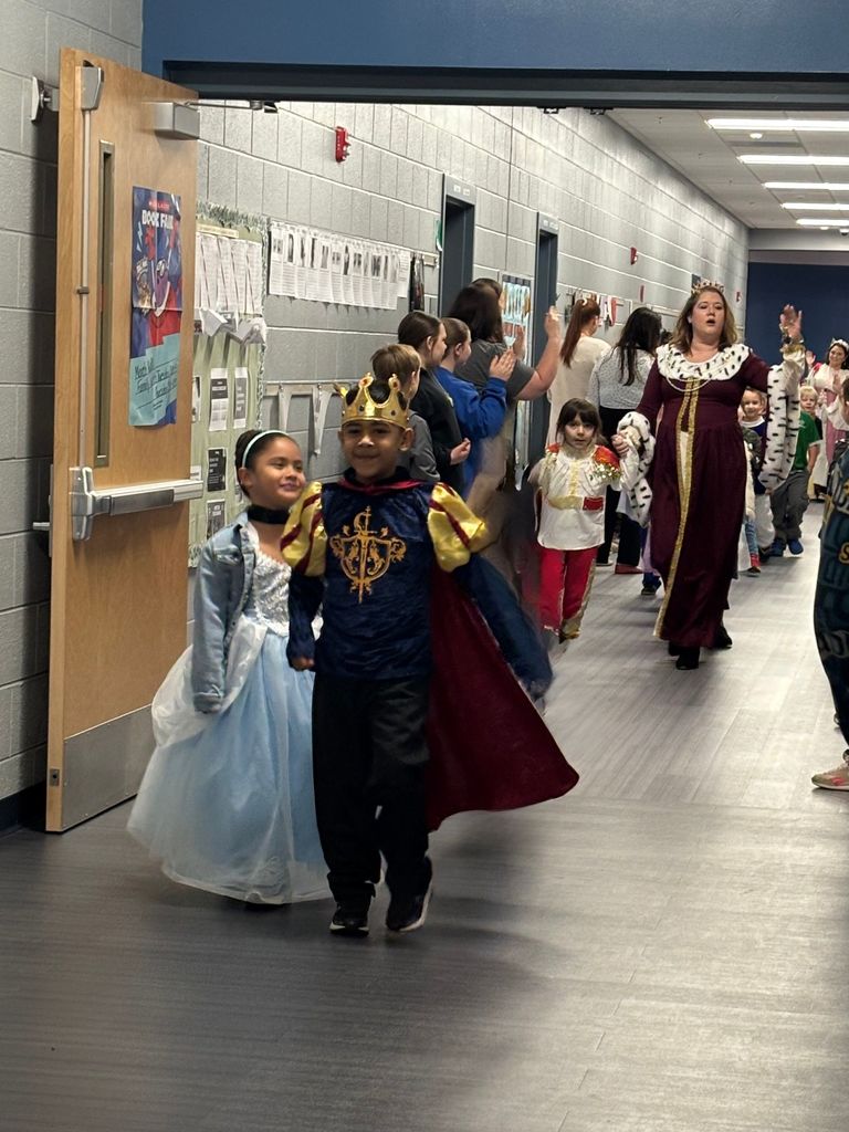 Students dressed as princesses and kings walking in a parade