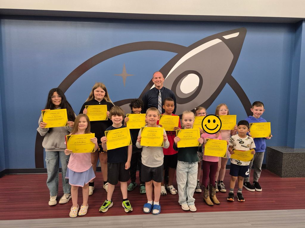 Students posing with Mr. Astorino with their certificates