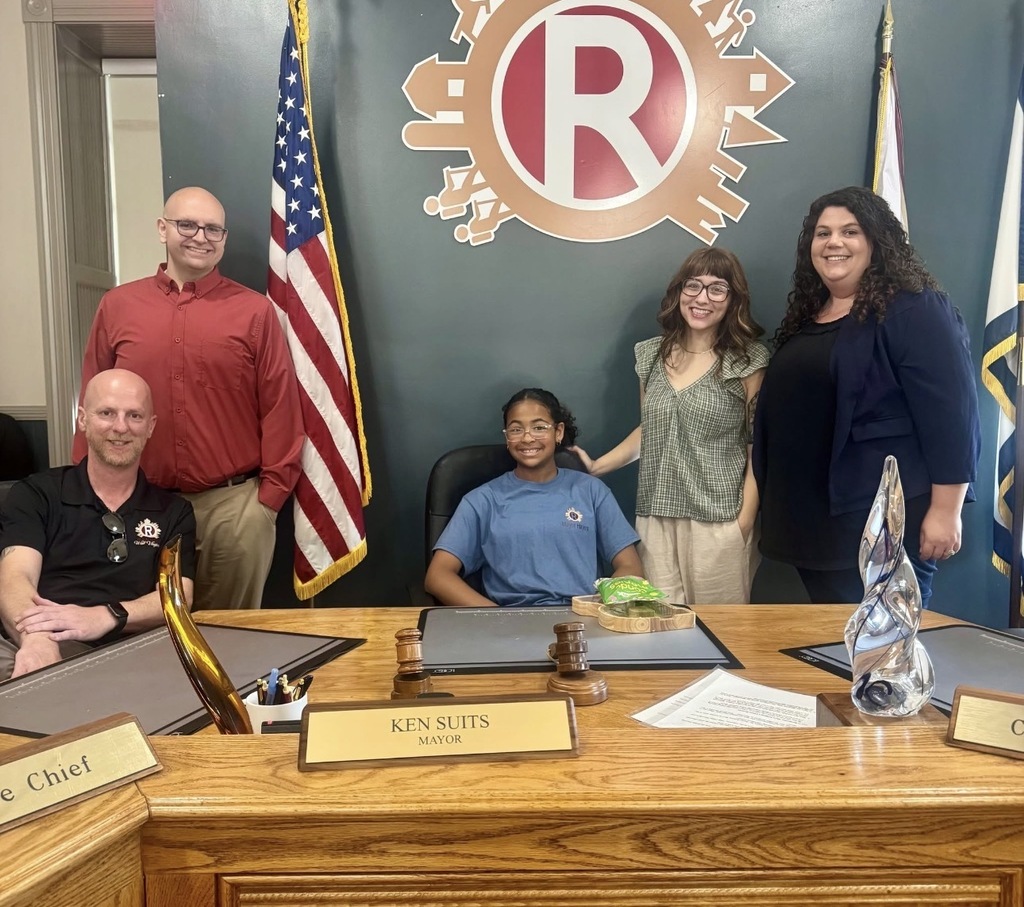 Fifth grade student Keira Hayes with council members and Ranson's mayor.