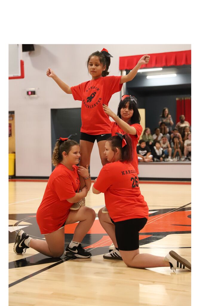 Fifth grader cheerleaders posing