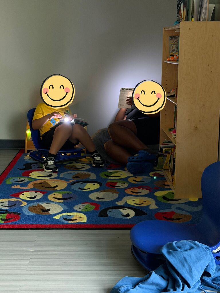 Two students reading with flashlights