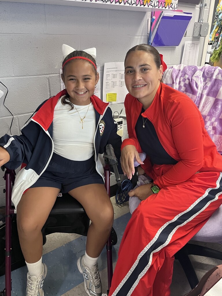 Mother and daughter staff and student dressed in red white and blue.