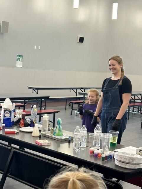 Parent and student showing elephant toothpaste