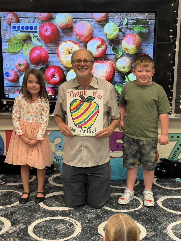 Students handing Mr. Artlip a Thank you card