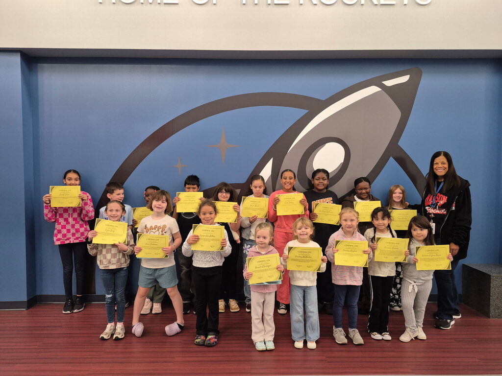 Students posing with Mrs. Terry with their certificates