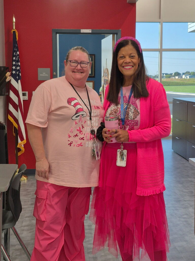 Mrs. Terry and Mrs. Schuyleman posing together in their pink outfits
