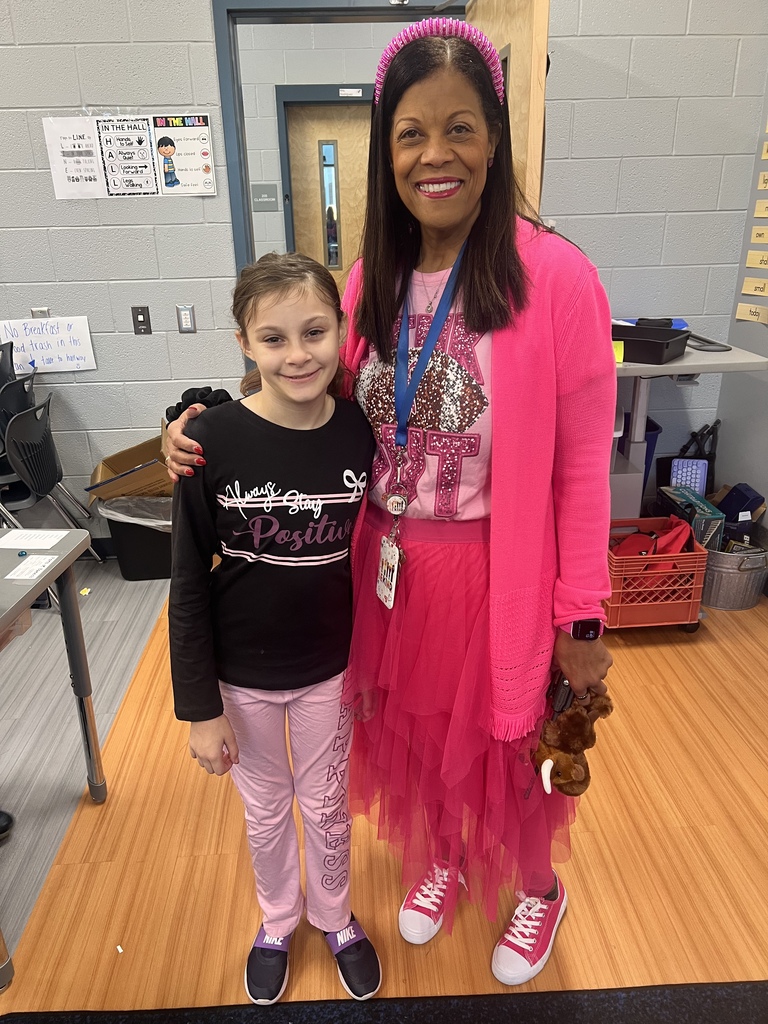 Mrs. Terry posing with a student dressed in pink