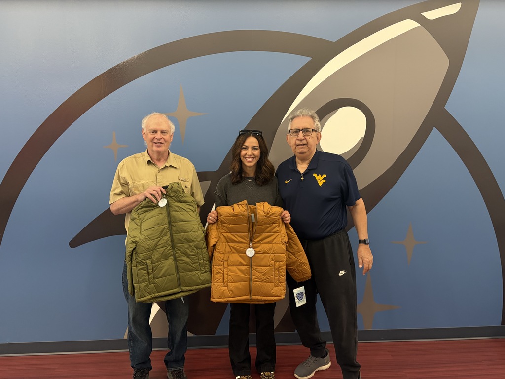 Lauren Walls with Knights of Columbus accepting the coat donation