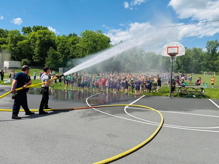 fire hose spraying on school kids