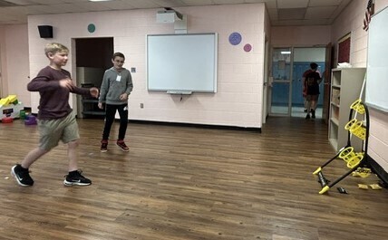 Students playing beanbag toss