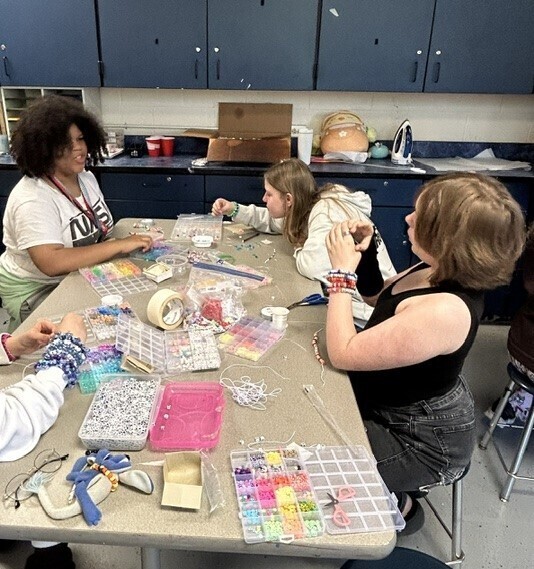 Students creating bead crafts
