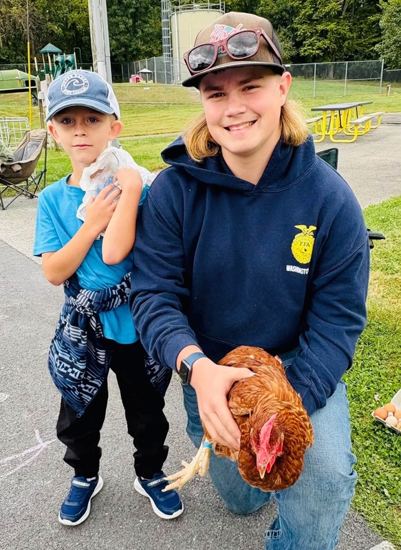 SJES student with a WHS student and chicken