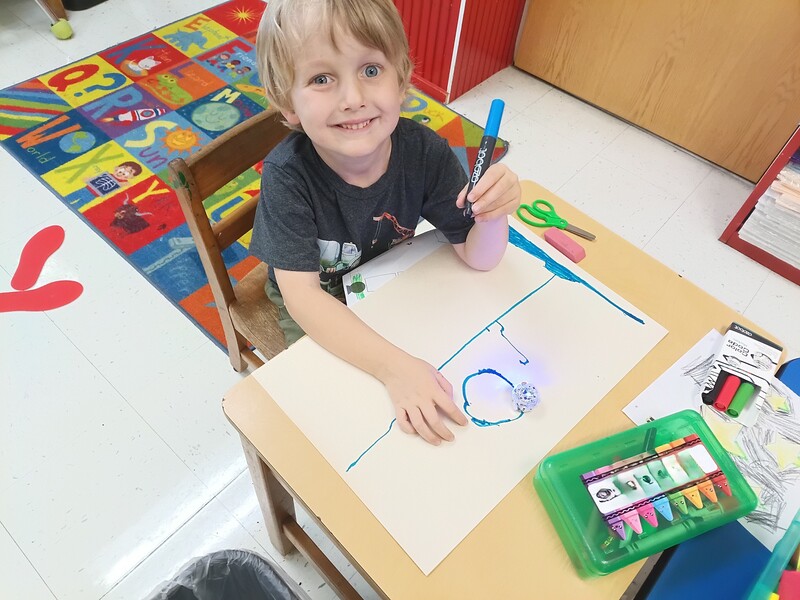 students using Ozobots to practice lines and circles