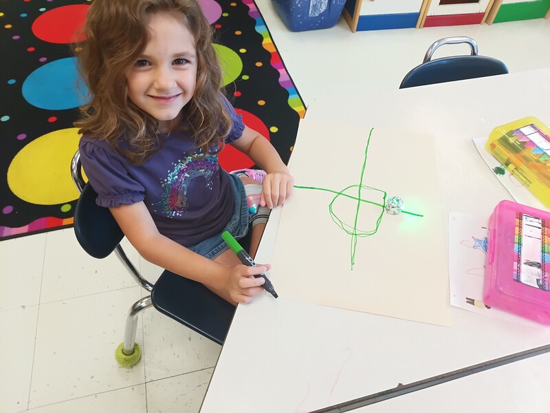 students using Ozobots to practice lines and circles