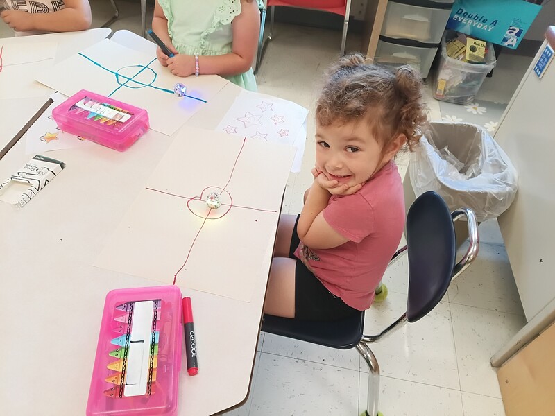 students using Ozobots to practice lines and circles