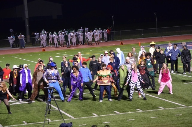 Students dancing on football field