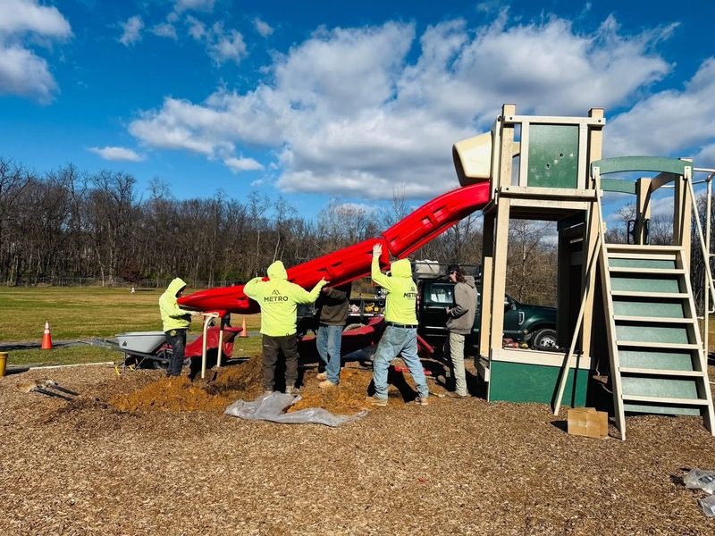 Metro Playground staff putting slide together