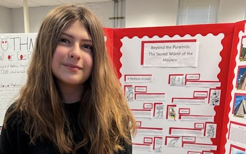 Student with Social Studies Fair project on the pyramids.