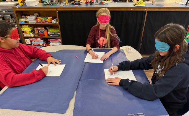 Students drawing with blindfolds on