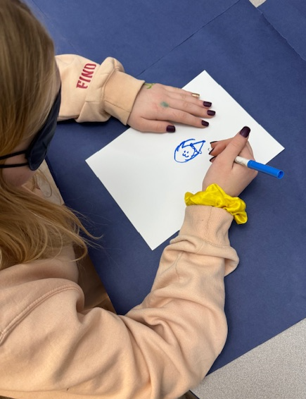 Student drawing with a blindfold on