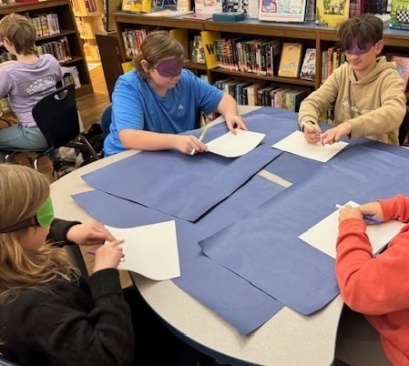 Students drawing with blindfolds on