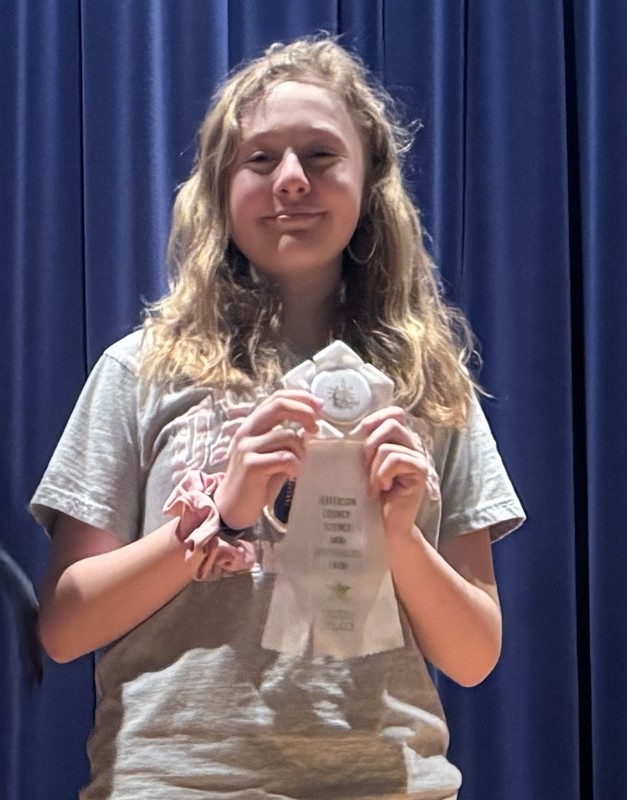 Student with ribbon at county Science Fair