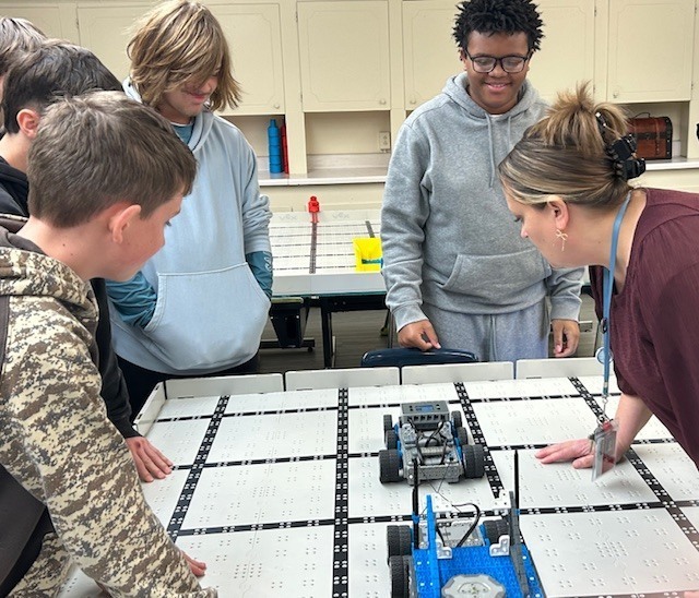 Students and teacher prepare robots to compete