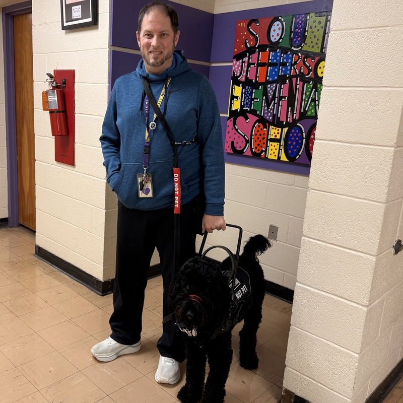 Mr Atkins and his service dog, Bella