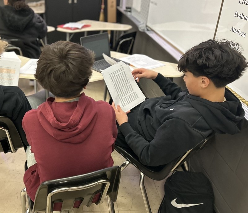 Students reading text in group