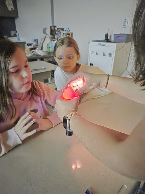Students candling eggs