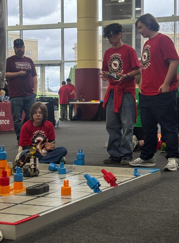 Students driving their robot on the field at the state robotics tournament