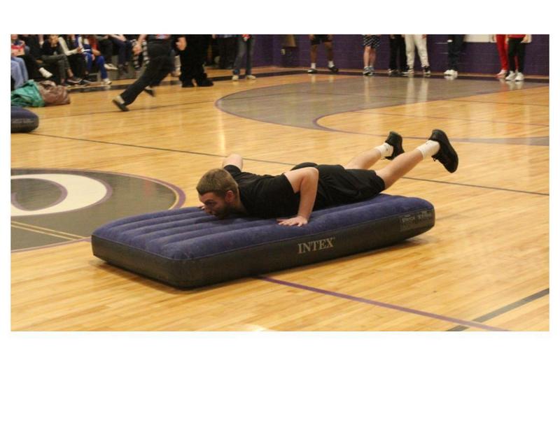 Staff sliding on mattress in Mattress Race